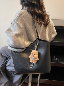 Vintage black tote bag in pleated wax leather with a cute teddy bear charm for daily commute