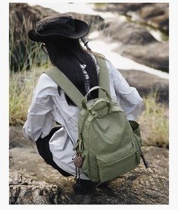 Detail of army green nylon backpack with soft texture and comfortable shoulder straps