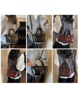 Multiple views of a vintage faux leather crossbody bag in black and burgundy red