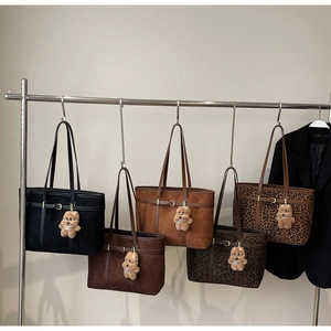 Selection of large suede tote bags in various colors and trendy leopard patterns