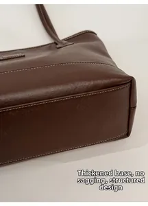 Detail of the reinforced base and white contrast stitching on a vintage tote bag