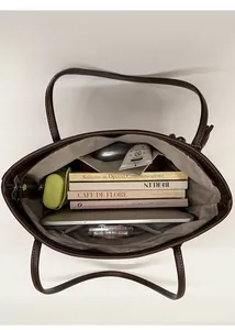 Internal view of brown leather tote bag showing large capacity and functional compartments