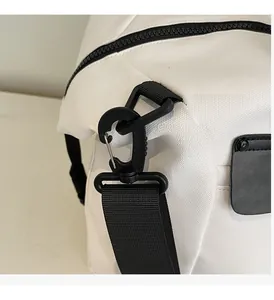 Detail of durable black detachable hook and nylon shoulder strap on white travel bag