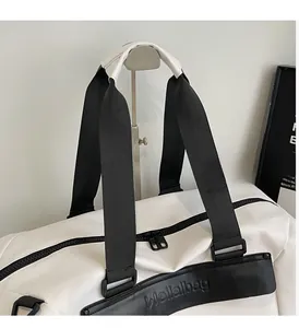 Close-up of durable reinforced stitching and handles on large capacity duffel bag