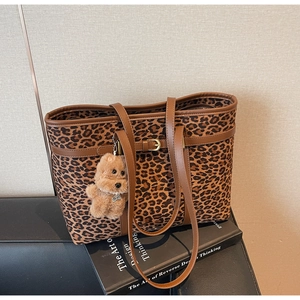 Detailed leopard print tote bag with brown leather straps and a cute teddy bear charm