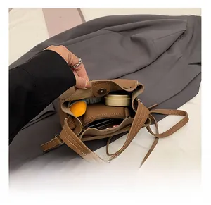 Interior view of brown pebble leather bucket bag showing capacity for daily essentials