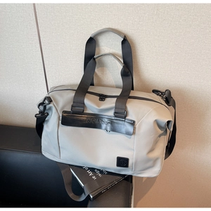 Close-up of light gray travel bag with black Meilaibag logo on premium nylon fabric
