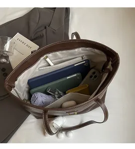 Interior view of large leather tote bag showing spacious capacity for daily essentials