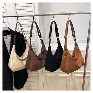 Detail view of large suede hobo shoulder bags in four colors with adjustable gold buckles