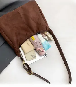 Interior view of large dark brown suede tote bag showing high storage capacity