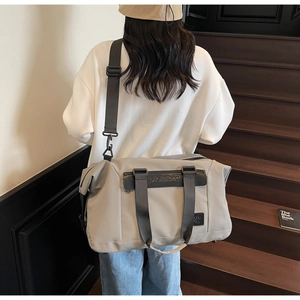 Close-up of grey fitness travel bag with adjustable strap and durable fabric texture