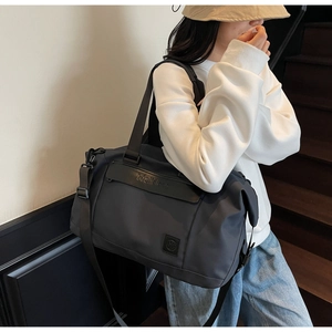 Close-up of durable travel duffel bag featuring sturdy handles and adjustable shoulder strap