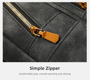 Close-up of golden metal zipper on textured grey leather backpack showing fine grain detail