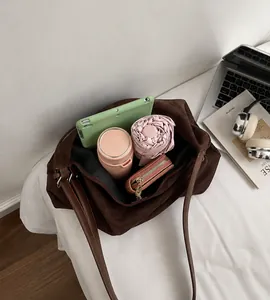 Interior view of large faux suede tote bag showing space for tablet and daily items