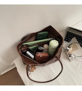 Detailed interior of large brown tote bag showing spacious compartments and storage
