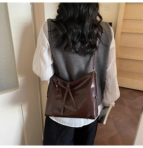 Deep brown oil-wax leather tote bag shown on shoulder for a stylish commuter look