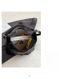 Top view showing the large capacity and quilted interior of this black chain tote bag