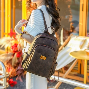 Detailed view of the dark brown matte leather vintage backpack with golden metal twist lock