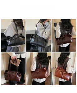 Detailed views of vintage large tote bag in black and brown leather worn by a model