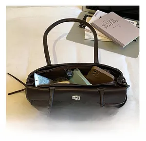 Detailed interior view of a dark brown quilted tote showing large storage capacity