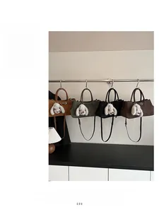 Detail showing high-quality suede tote bags in brown, green, black and coffee colors