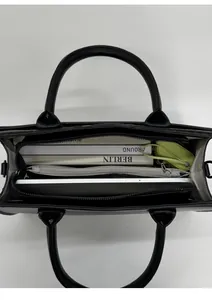 Top view of large black tote bag with multiple compartments showing high storage capacity
