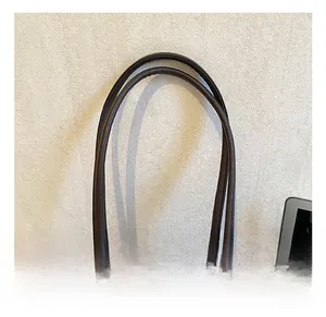 Close-up of the vintage dark brown leather tote bag handle with silver metal rings