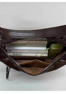 Top view detail of dark brown vintage leather shoulder bag with large internal capacity
