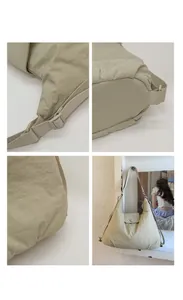 Detail view of large beige nylon tote with adjustable strap and textured fabric