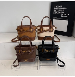 Detail view of retro chic bucket bags in four colors with gold metal hardware