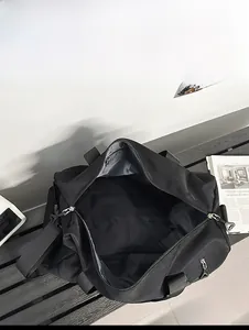 Top view of large black gym bag showing spacious interior with double zippers and gray lining