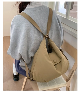 Detail of khaki quilted nylon backpack showing soft texture and covered button on flap