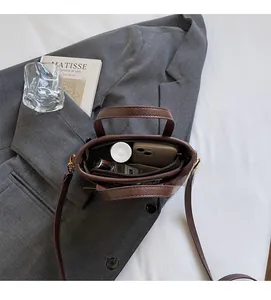 Macro detail of spacious interior in brown vintage leather handbag with items