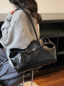 Vintage black leather tote bag with glossy finish and silver buckles for women