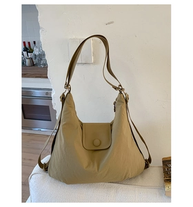 Detail of khaki nylon tote bag showing durable fabric texture and adjustable buckle strap