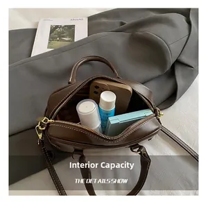 Detail view of the spacious internal capacity of this dark brown vintage pillow bag