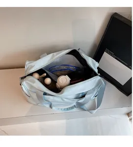 Detailed top view of light blue travel bag interior showing spacious storage compartments