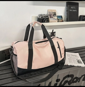 Pink and black fitness bag with shoe compartment shown in a stylish travel setting