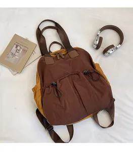 Detailed view of lightweight nylon backpack with drawstring pockets and bi-color design