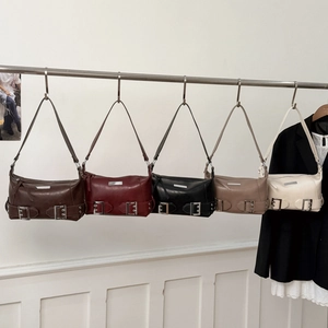 Fashion motorcycle leather shoulder bags in five colors hanging on a modern rack