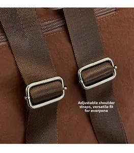 Detail of adjustable nylon straps with silver metal buckles on a brown travel backpack