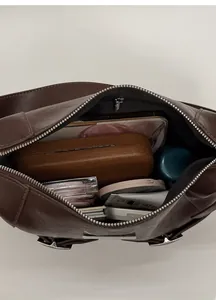 Interior view of deep brown vintage underarm bag showing spacious storage for daily items
