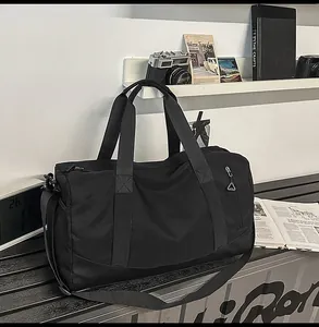 Detail of black gym bag with separate shoe compartment and adjustable shoulder strap