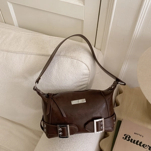 Detailed view of dark brown leather underarm bag with silver buckle and hardware