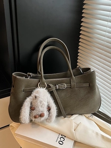 Olive green matte leather tote bag with buckle detail and white plush bunny charm