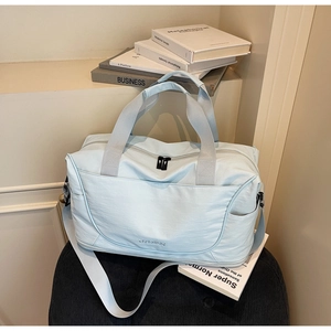 Light blue waterproof nylon travel bag with durable handles and adjustable shoulder strap