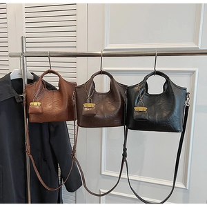 Detailed close-up of retro leather tote bags in brown and black with mini coin pouches