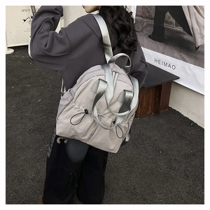 Detail view of water-resistant nylon backpack with drawstring closure and side pockets