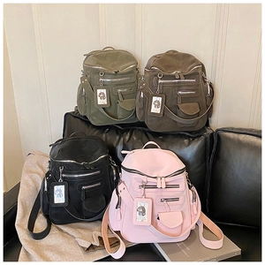 Close-up of stylish backpacks in army green, dark coffee, black, and cherry pink colors