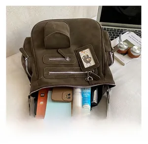 Detailed interior of a dark brown large tote showing storage for tablets and gadgets